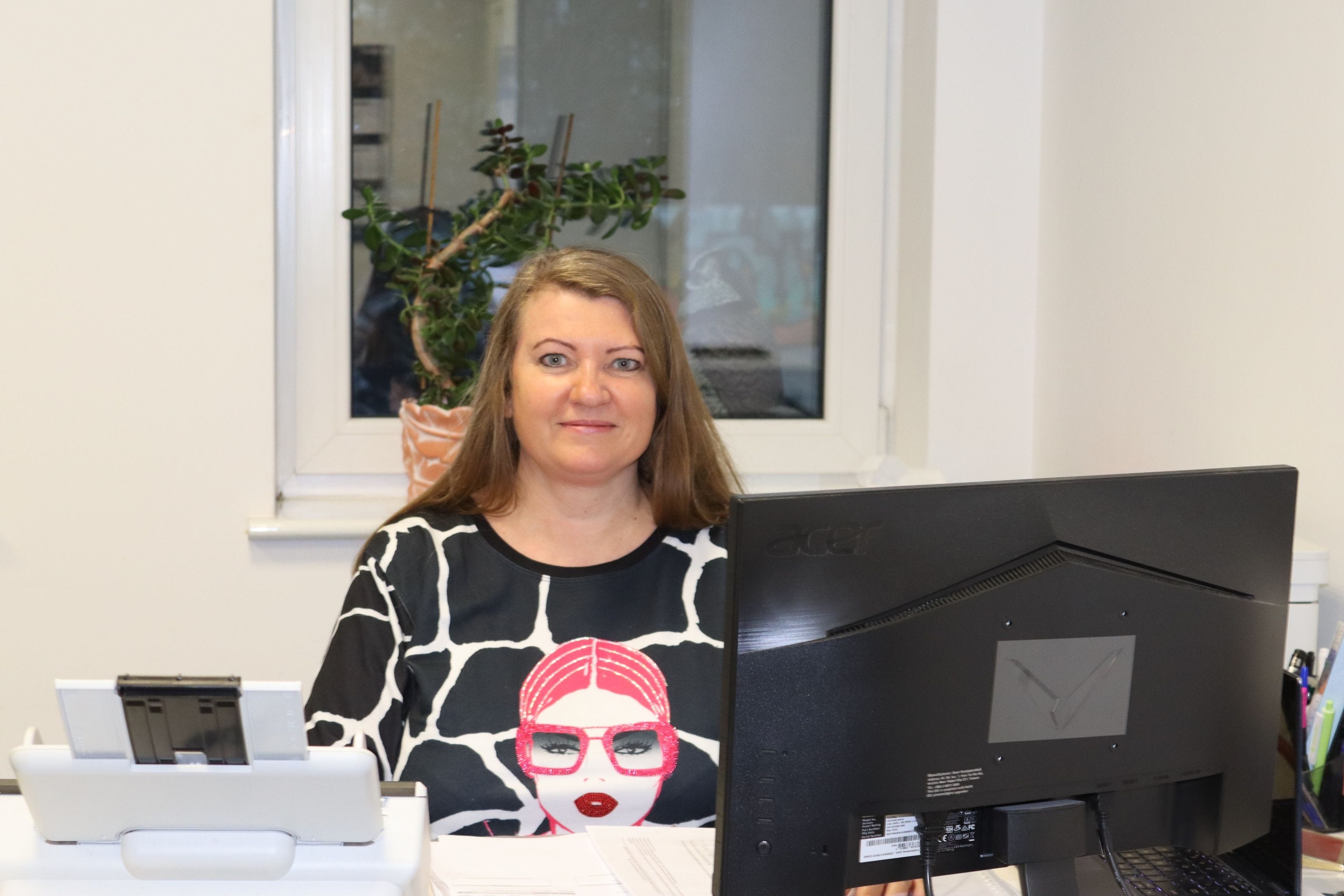 Martyna Kowalczyk at her desk in the office